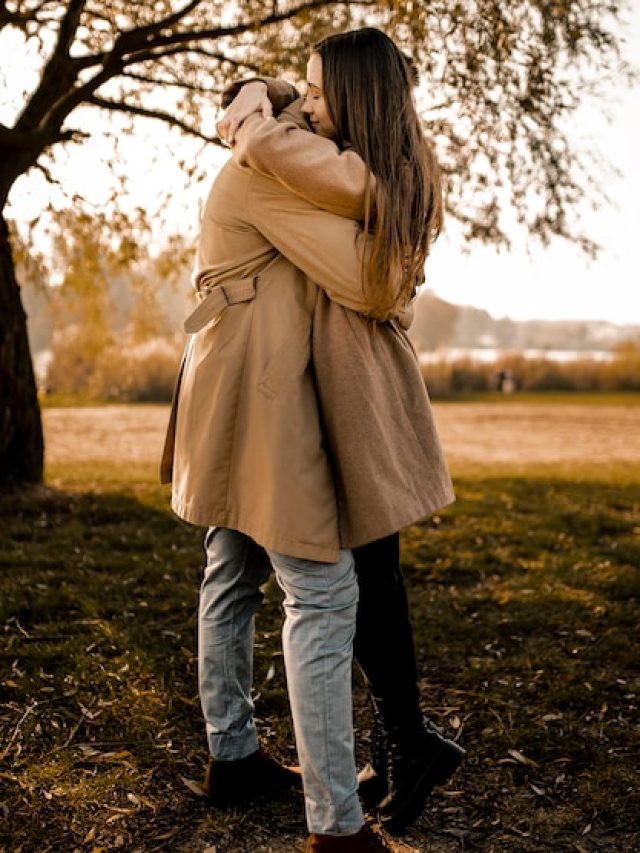 full-shot-couple-hugging-outdoors_23-2148755725